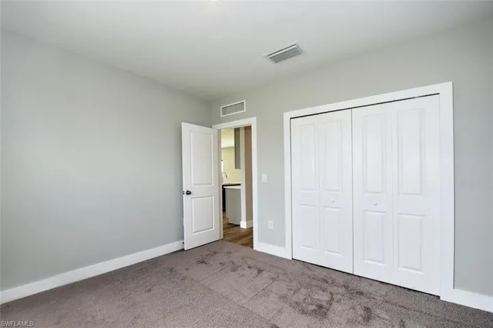 Unfurnished bedroom with a closet and carpet
