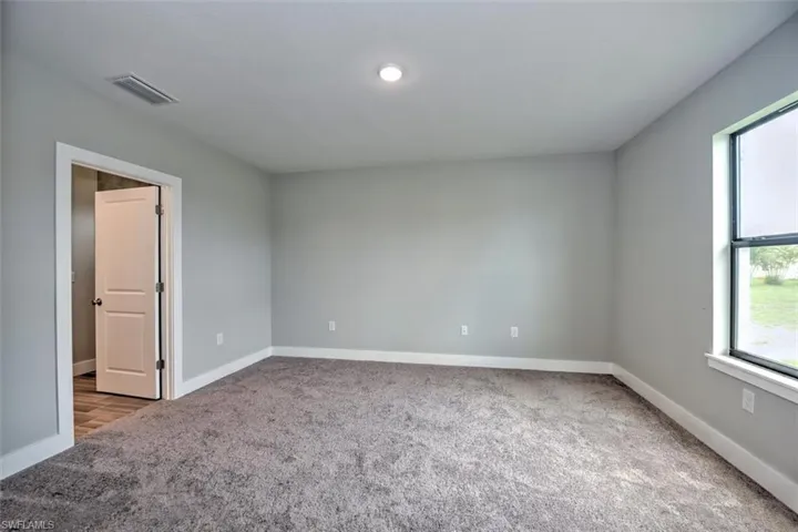 Unfurnished room with carpet flooring