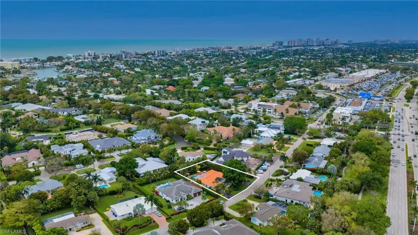 Aerial view of property's location with property parcel outlined and nearby suburban area
