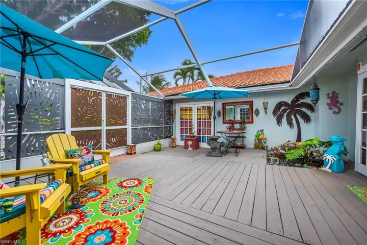 Sunroom featuring a wooden deck and outdoor dining area