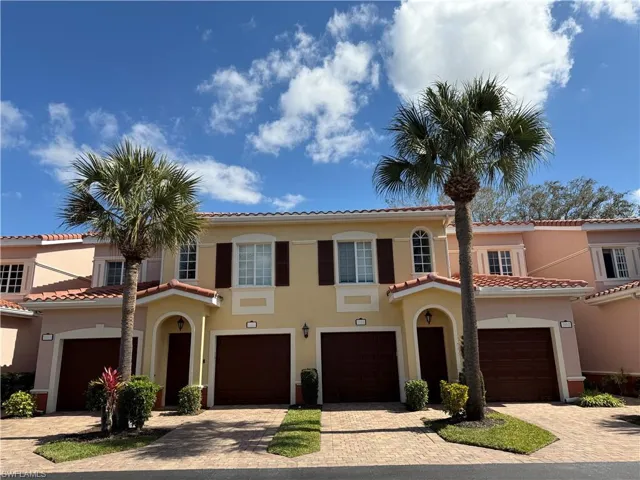 Mediterranean / spanish home featuring stucco siding, driveway, and a tiled roof