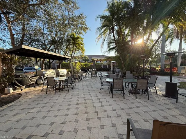 View of patio with outdoor dining space and area for grilling