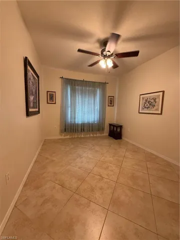 Unfurnished room featuring a ceiling fan and light tile patterned flooring