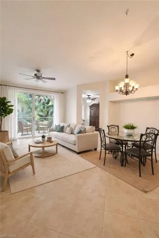 Living area featuring ceiling fan, a chandelier, and light tile patterned floors
