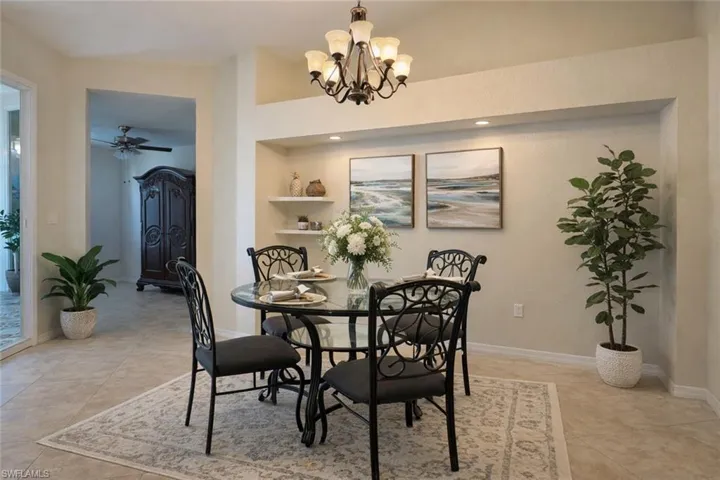 Dining space featuring suspended lighting, a ceiling fan, and light tile patterned floors
