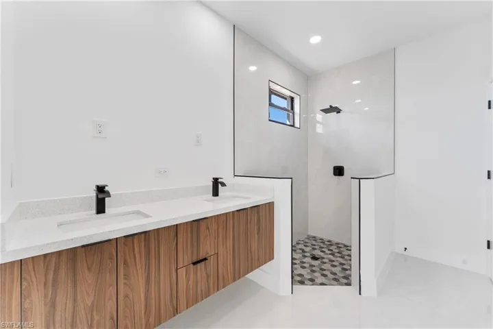 Bathroom with vanity and a tile shower