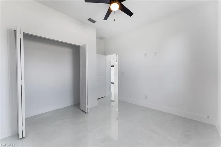 Unfurnished bedroom featuring ceiling fan