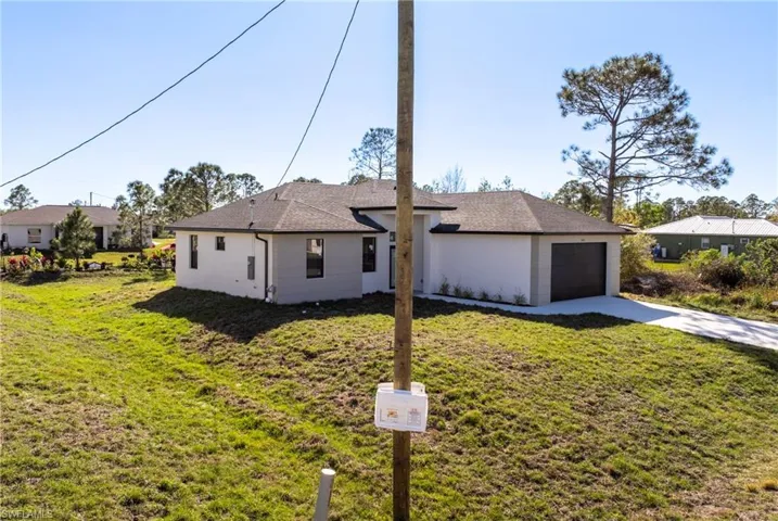 Ranch-style house with a garage and a front yard