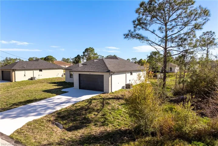 View of front of home featuring central AC and a front yard