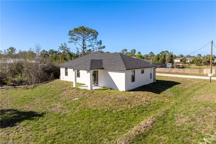 View of property exterior with a lawn