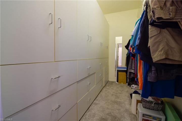 Walk in Closet with wall of built-in storage