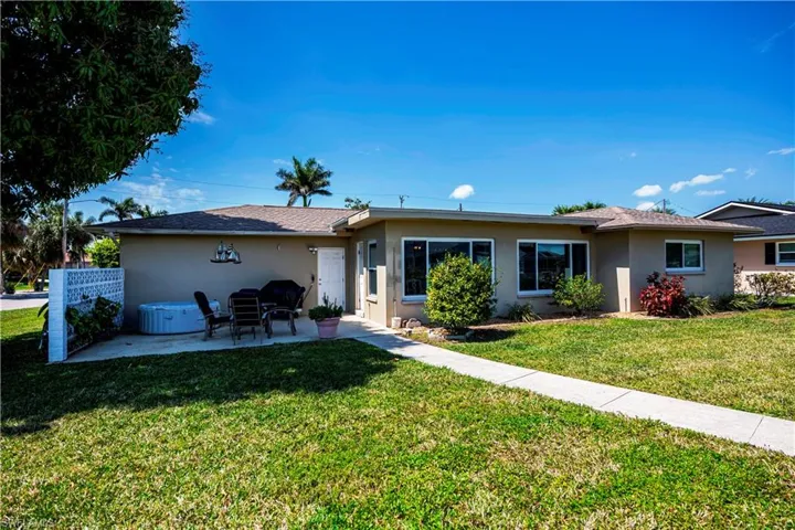 Rear view of the home. Great shade for patio from your mango tree.