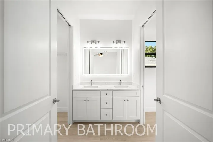 Bathroom with vanity and wood-type flooring