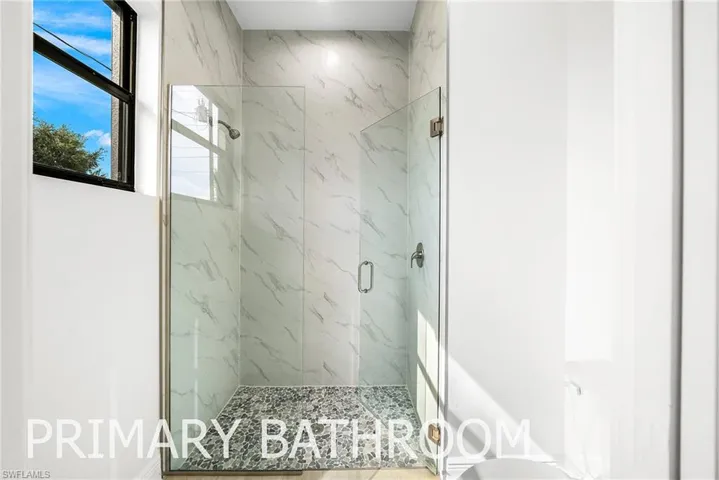 Bathroom featuring toilet and an enclosed shower