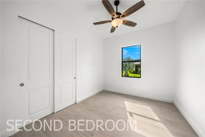 Unfurnished bedroom with light hardwood / wood-style floors, ceiling fan, and a closet