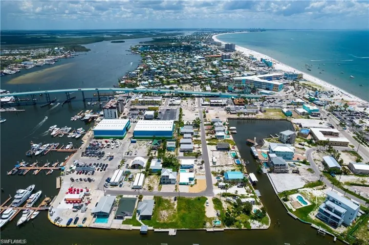 Birds eye view of property with a water view