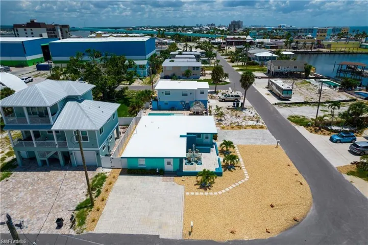 Birds eye view of property with a water view