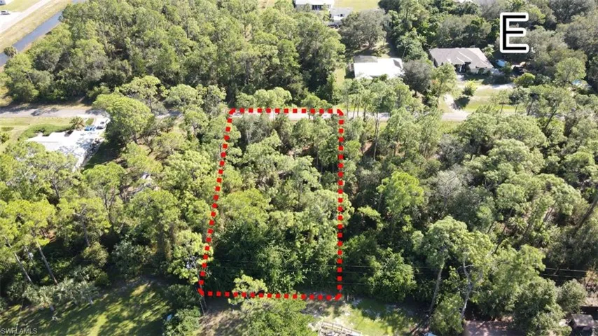 Aerial overview of property's location featuring a heavily wooded area and property parcel outlined