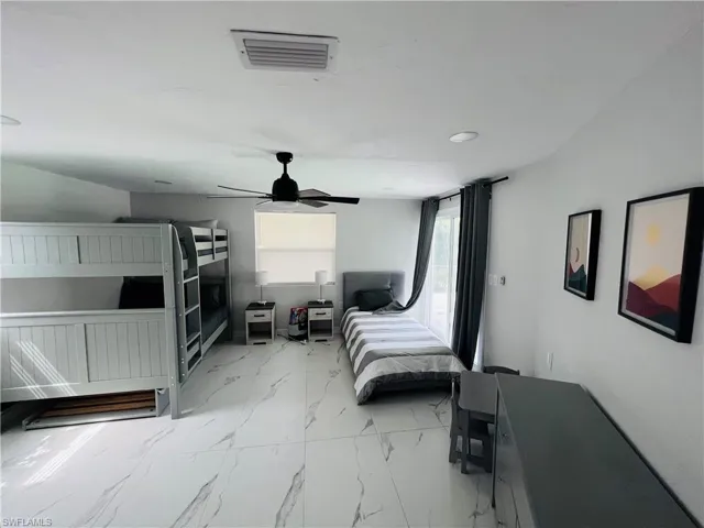 White tile flooring with grey veining, ceiling-mounted light fixture, recessed lighting, and a window with blinds