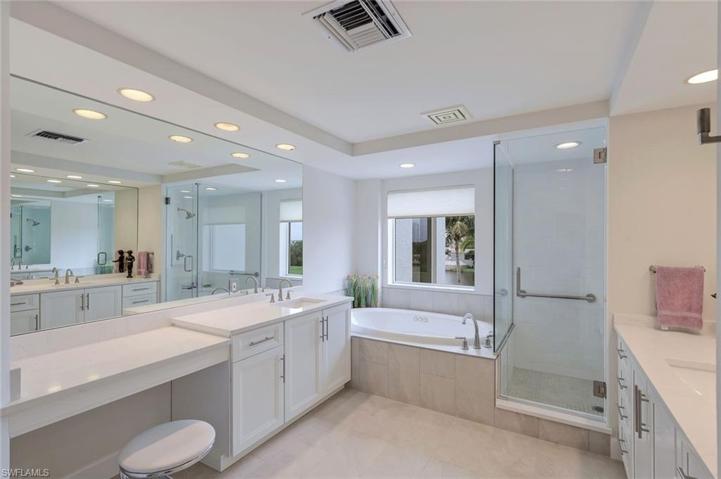 There is plenty of room for TWO in this primary en-suite bathroom. Walk in shower, soaking tub, two separate sink/counter areas, & a vanity area.