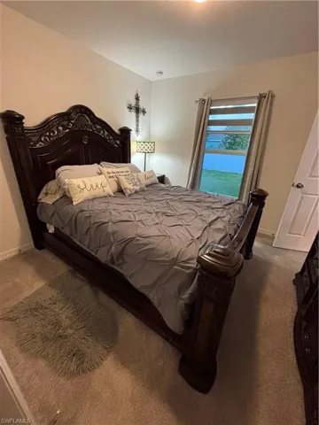 Carpeted bedroom featuring baseboards