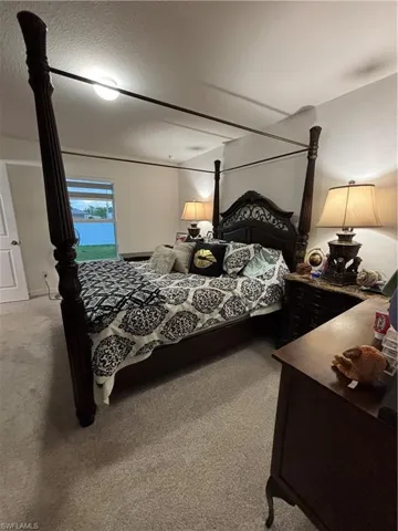 Carpeted bedroom featuring a textured ceiling