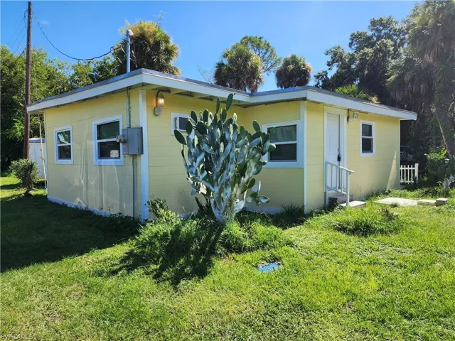 View of side of home with a lawn