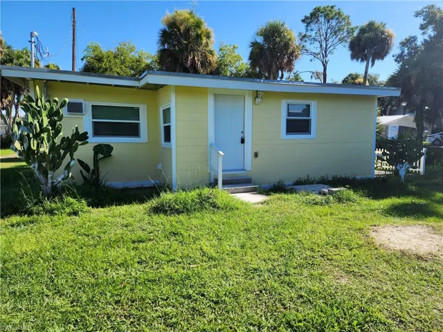 View of back of house with a lawn