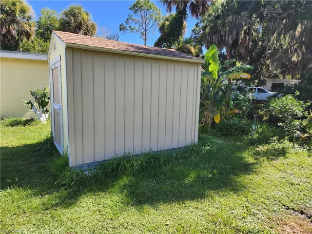 View of outbuilding with a yard