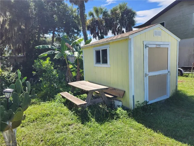 View of outbuilding with a yard