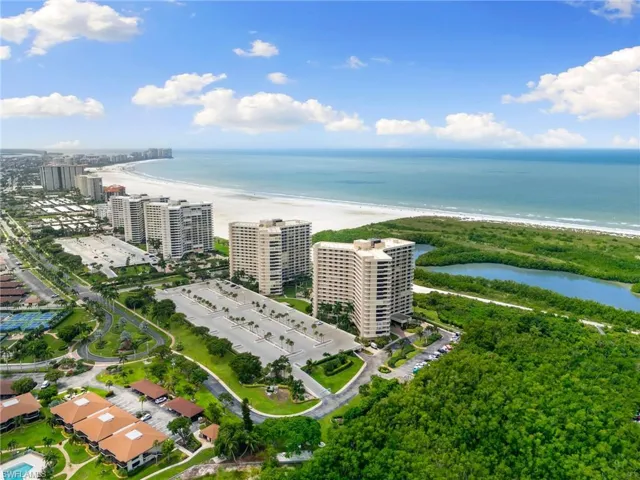 Birds eye view of property with a view of the beach and a water view