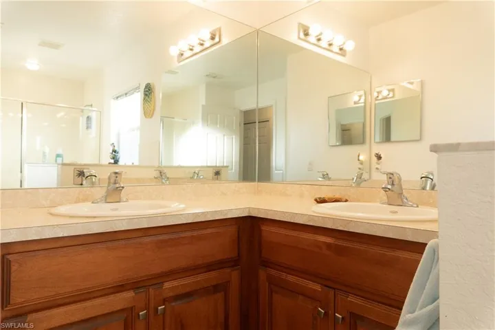 Bathroom featuring vanity and a shower with shower door
