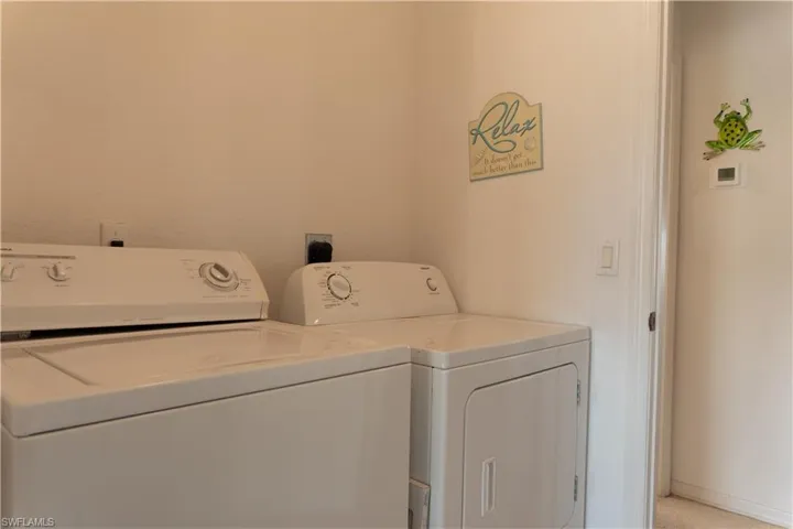 Washroom featuring washing machine and dryer