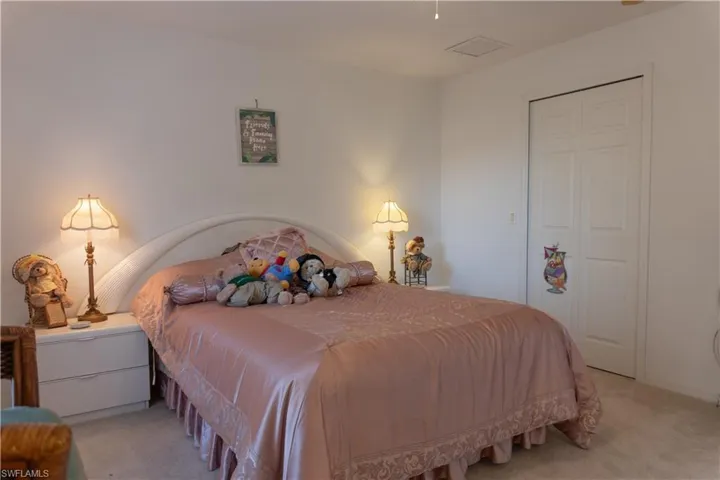 Bedroom with light colored carpet