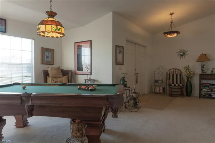 Playroom with vaulted ceiling, billiards, and carpet flooring