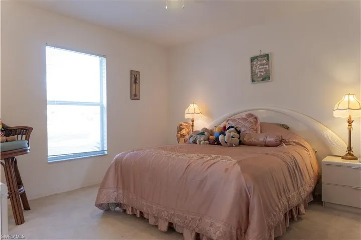 Bedroom with light colored carpet