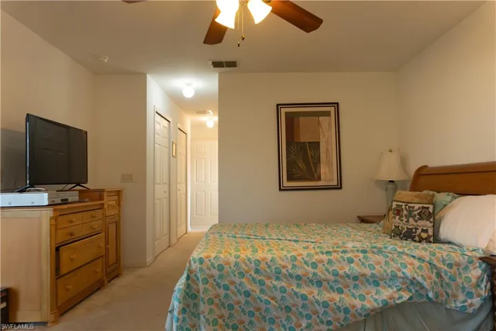 Carpeted bedroom with ceiling fan