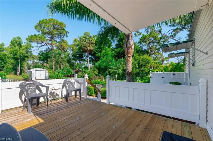Wooden terrace featuring a shed