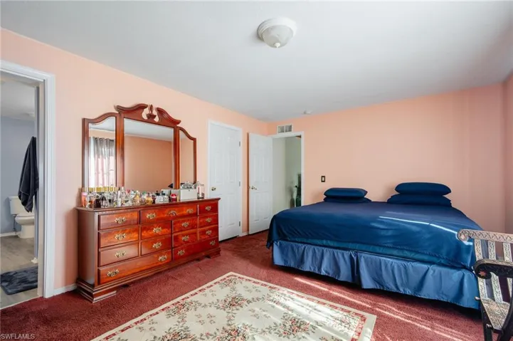 Bedroom with carpet floors and ensuite bath