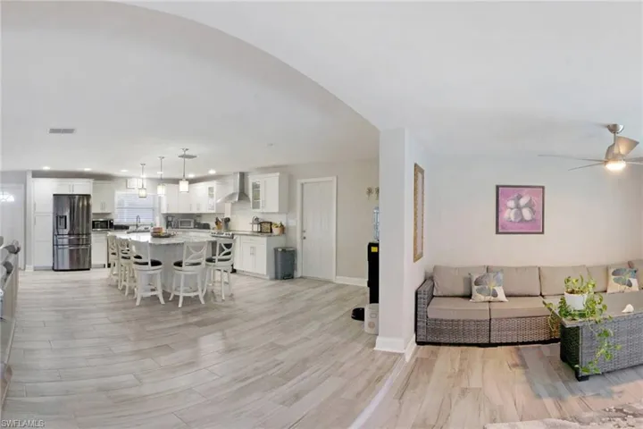 Living room with light wood finished floors and recessed lighting