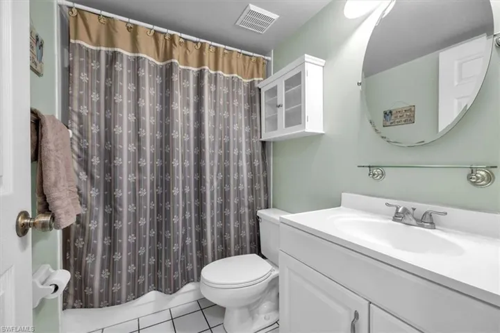 Bathroom with vanity and light tile patterned floors