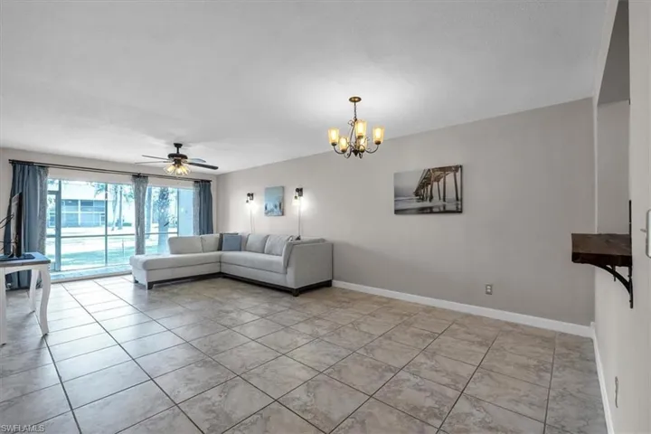 Living area with a ceiling fan and a chandelier