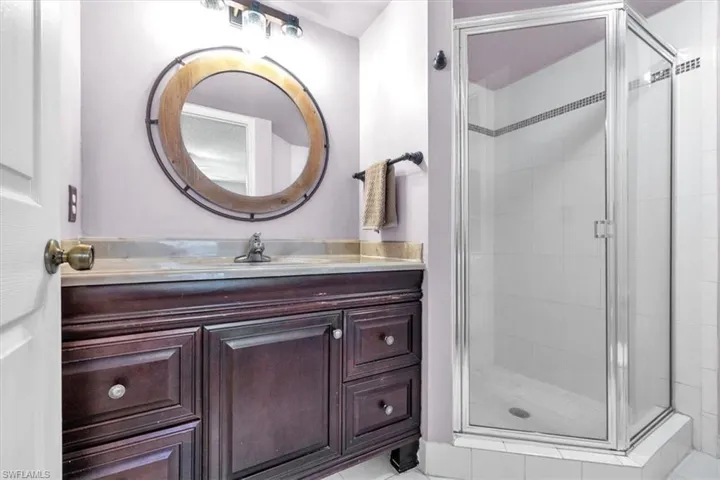 Bathroom with vanity and a shower stall