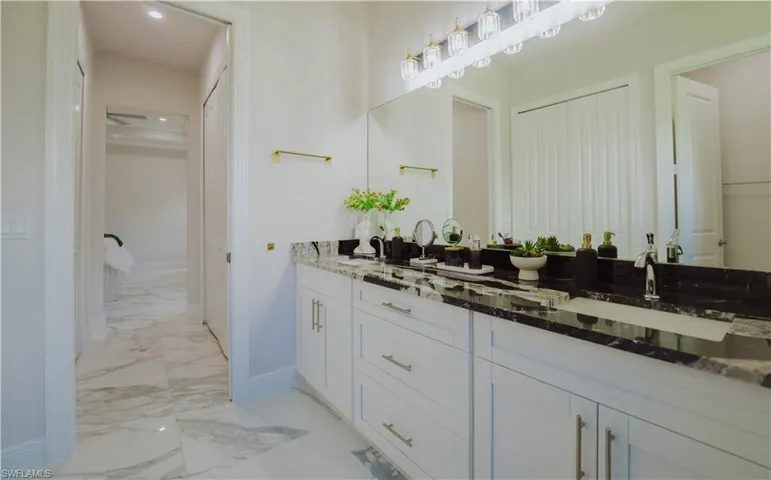 Bathroom with tile floors and dual bowl vanity