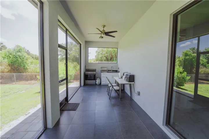 Sunroom with sink and ceiling fan