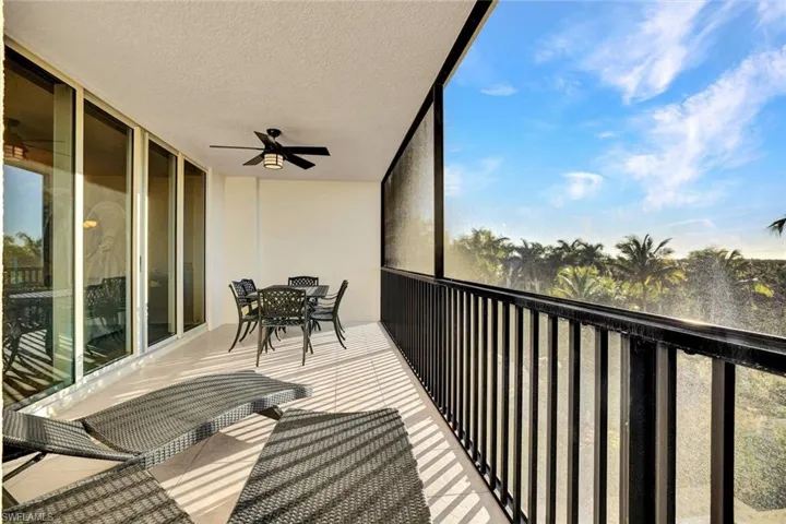 Balcony with outdoor dining area and ceiling fan