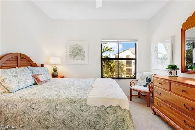 Bedroom featuring light carpet and a ceiling fan