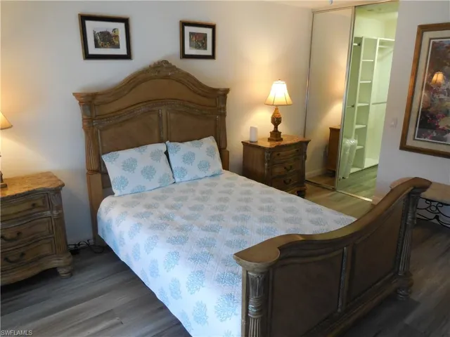 Bedroom with baseboards and wood finished floors