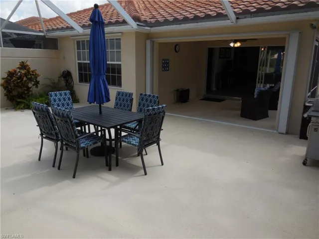 View of patio with glass enclosure and outdoor dining space