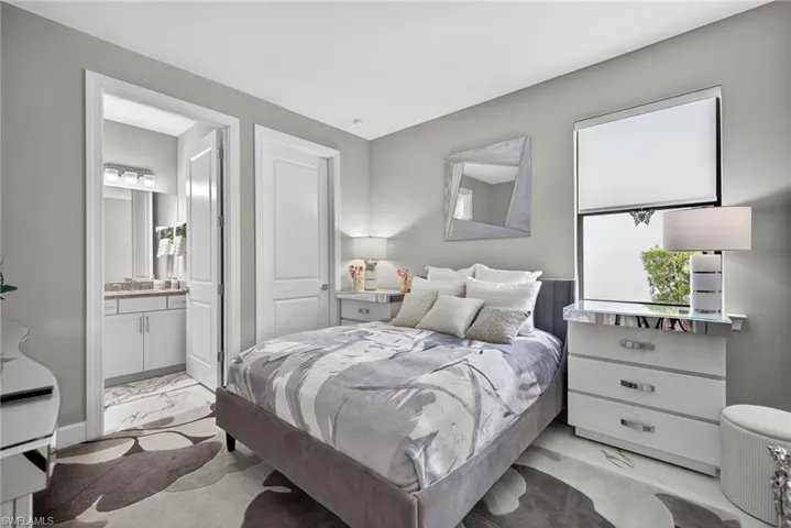 Bedroom with baseboards and ensuite bath